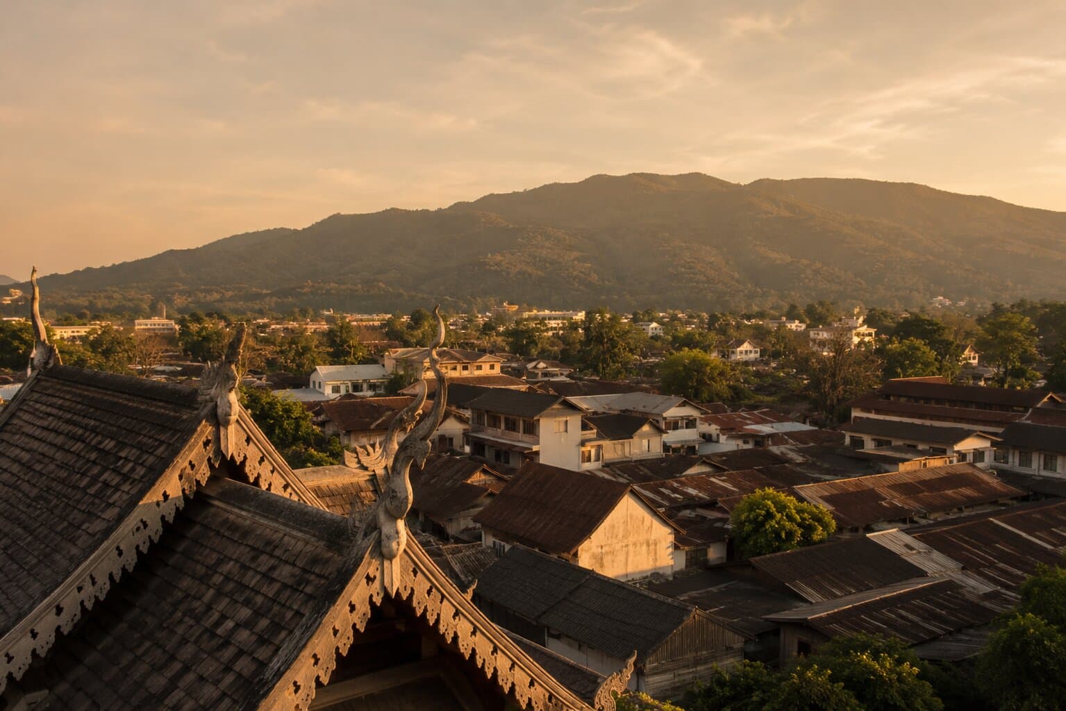 Editorial view of Chiang Mai's old town under misty mountains