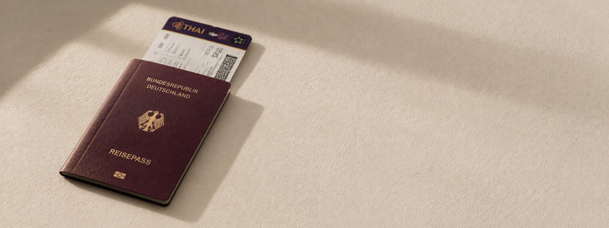 Editorial still life of an open passport on warm paper