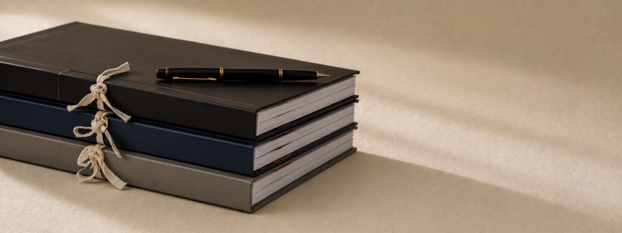 Editorial still life of bound case files with a fountain pen