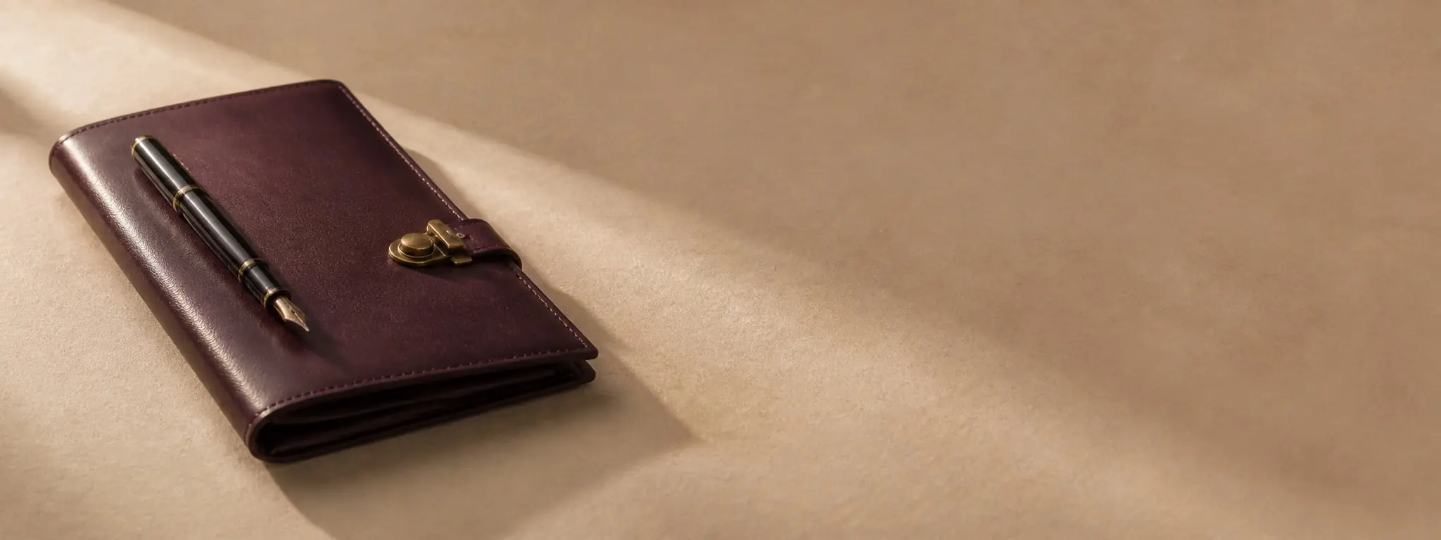 Editorial still life of an open notebook, fountain pen and key